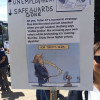 Protestor's sign showing Trump Peeing into a fan and getting it all over his face