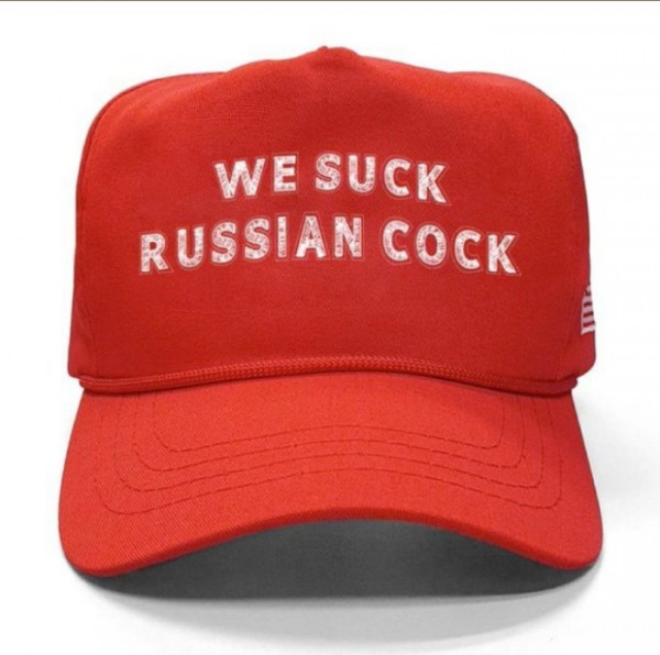 Red MAGA hat that reads WE SUCK RUSSIAN COCK